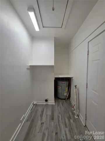 a room with wooden floor and utility room