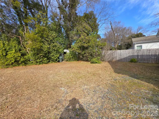 a view of a yard with a tree
