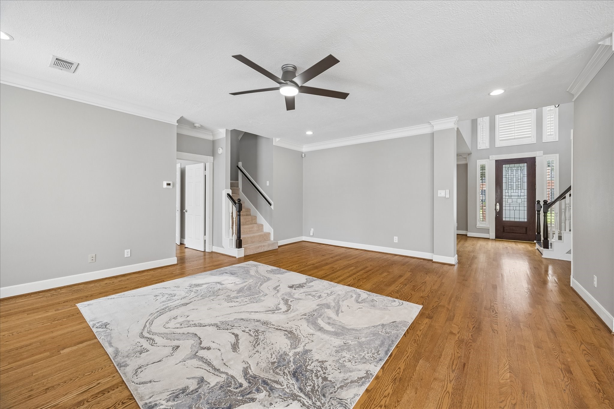 7915 Huddersfield Court Spring, TX 77379 - Photo 15 of 37 Alternate view of the family room showing its generous scale, hardwood floors, fresh neutral paint, and easy connection back to the two-story foyer.