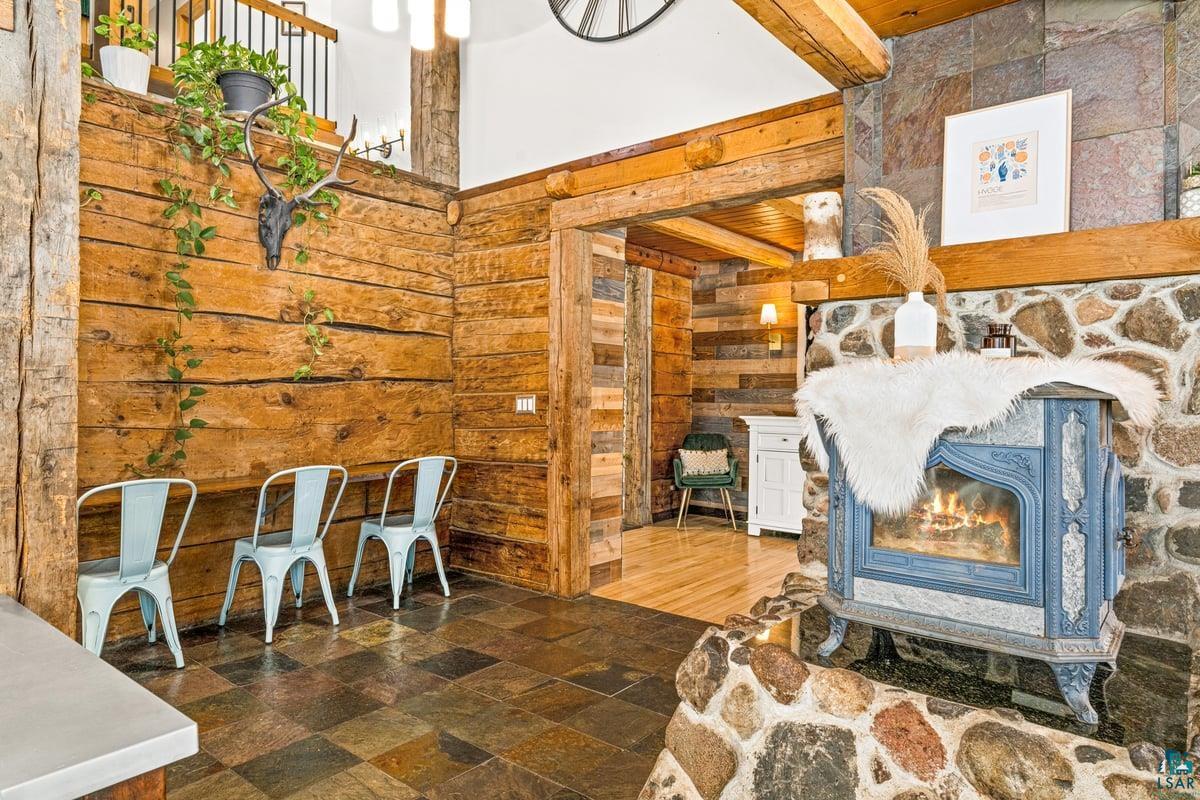 27 West Stark Road Esko, MN 55733 - Photo 16 of 47 Living area with wood walls and dark stone finish floors
