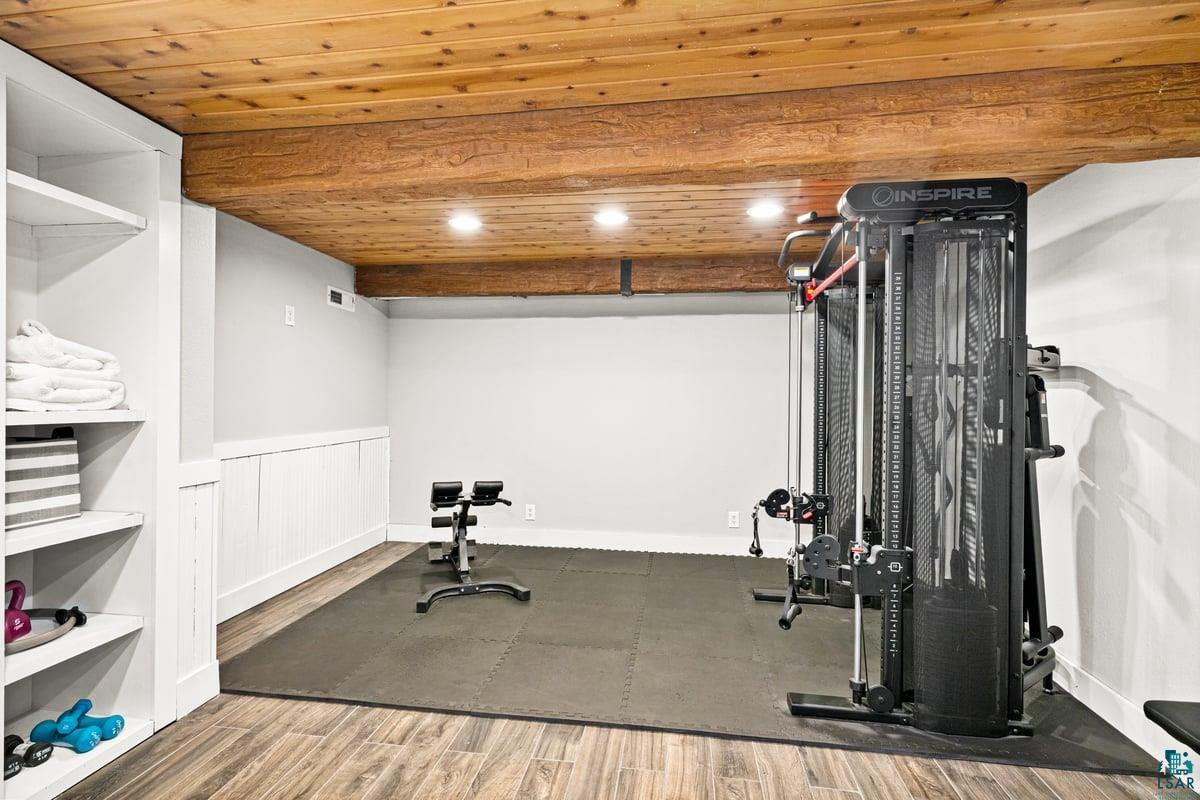 27 West Stark Road Esko, MN 55733 - Photo 38 of 47 Workout area featuring wood finished floors, wooden ceiling, wainscoting, and recessed lighting