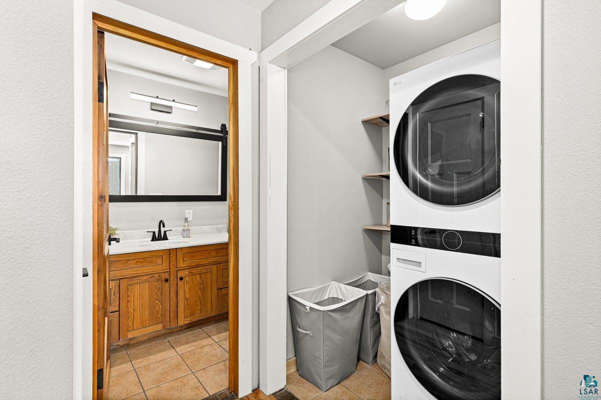 27 West Stark Road Esko, MN 55733 - Photo 39 of 47 Laundry area featuring stacked washer and dryer and light tile patterned floors