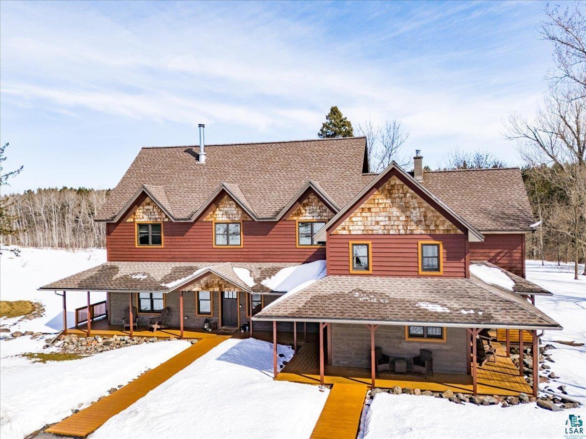 27 West Stark Road Esko, MN 55733 - Photo 4 of 47 View of front facade with covered porch, roof with shingles, and a chimney