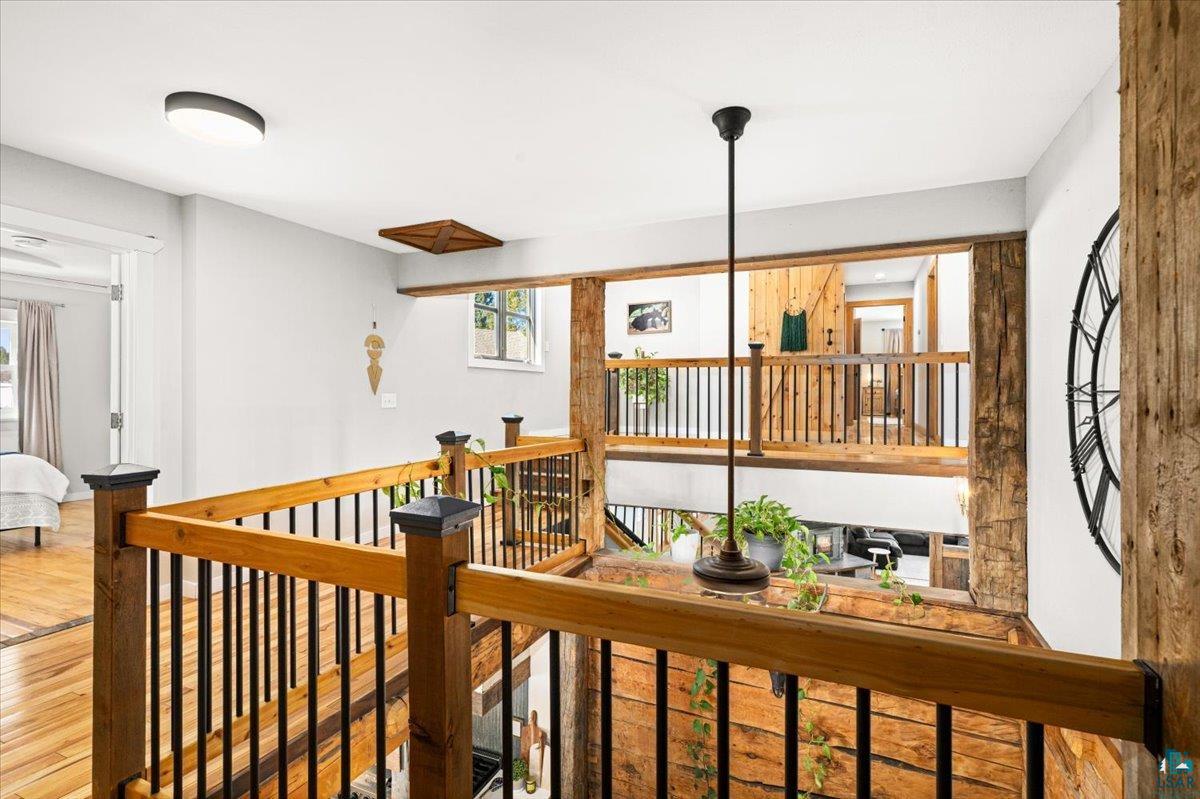 27 West Stark Road Esko, MN 55733 - Photo 41 of 47 Corridor with wood finished floors and an upstairs landing
