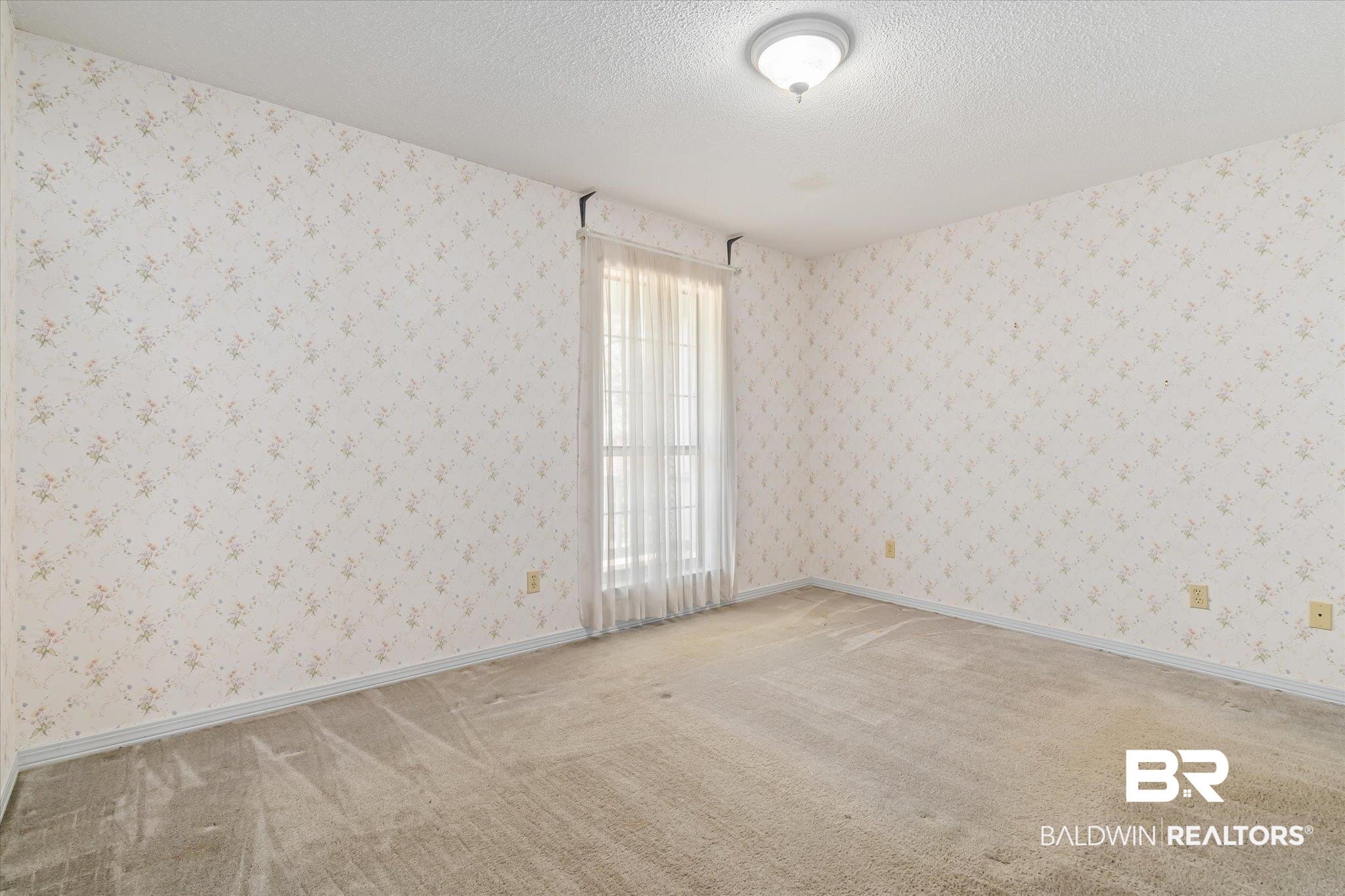 6030 Lott Road Eight Mile, AL 36613 - Photo 15 of 21 Spare room featuring carpet flooring, wallpapered walls, baseboards, and a textured ceiling