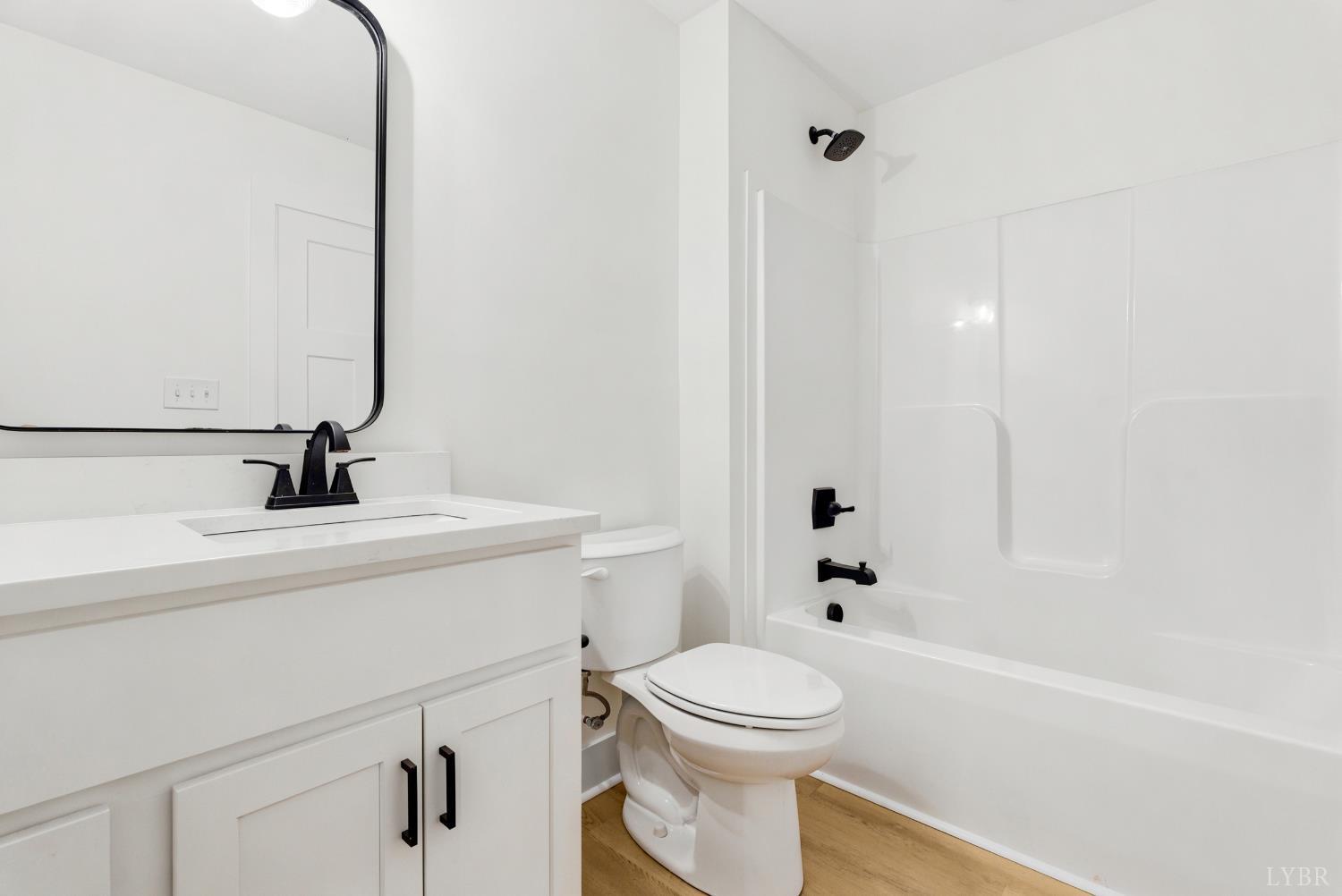 556 Leesville Road, Unit 406 Lynchburg, VA 24502 - Photo 26 of 39 a bathroom with a sink a toilet and shower