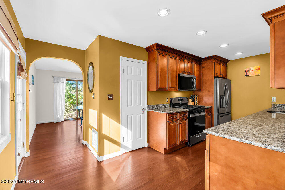 345 Green Grove Road Tinton Falls, NJ 07712 - Photo 15 of 80 a kitchen with stainless steel appliances granite countertop a refrigerator a stove and a sink