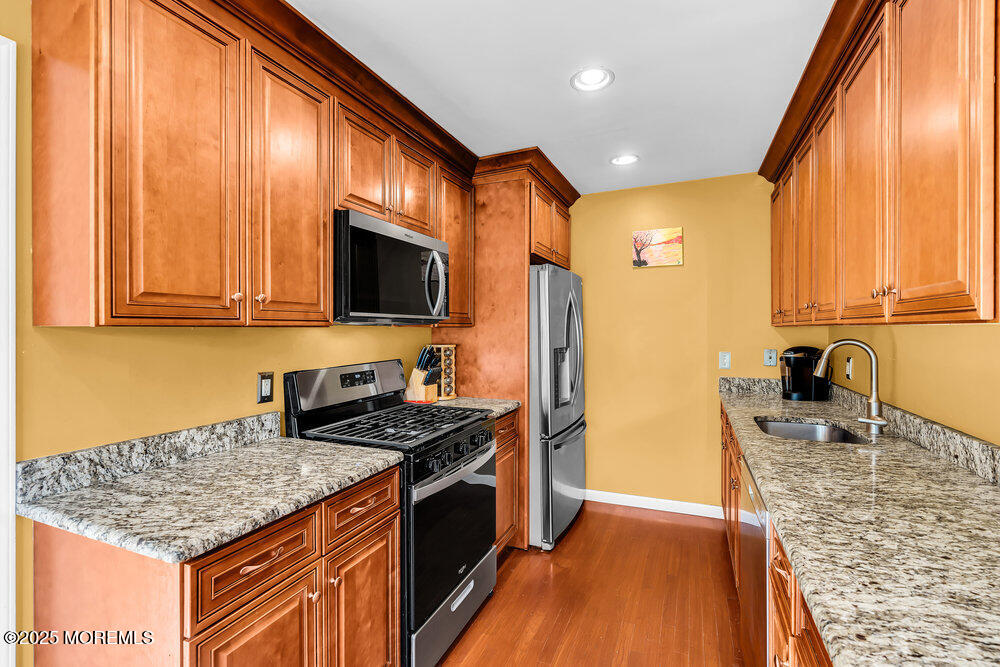 345 Green Grove Road Tinton Falls, NJ 07712 - Photo 18 of 80 a kitchen with stainless steel appliances granite countertop a sink stove and refrigerator