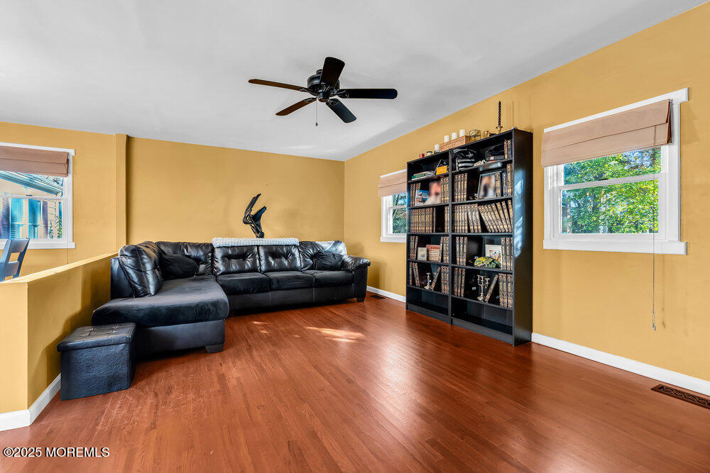 345 Green Grove Road Tinton Falls, NJ 07712 - Photo 23 of 80 a living room with furniture and a book shelf