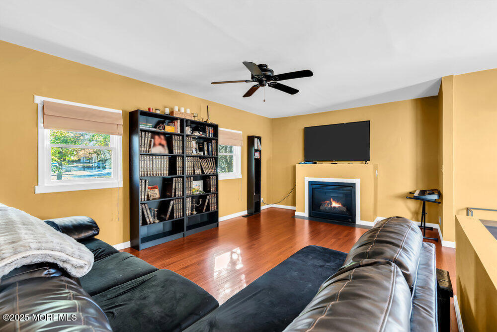 345 Green Grove Road Tinton Falls, NJ 07712 - Photo 26 of 80 a living room with furniture and a fireplace