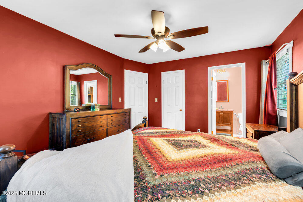 345 Green Grove Road Tinton Falls, NJ 07712 - Photo 29 of 80 a bedroom with a bed and a large mirror