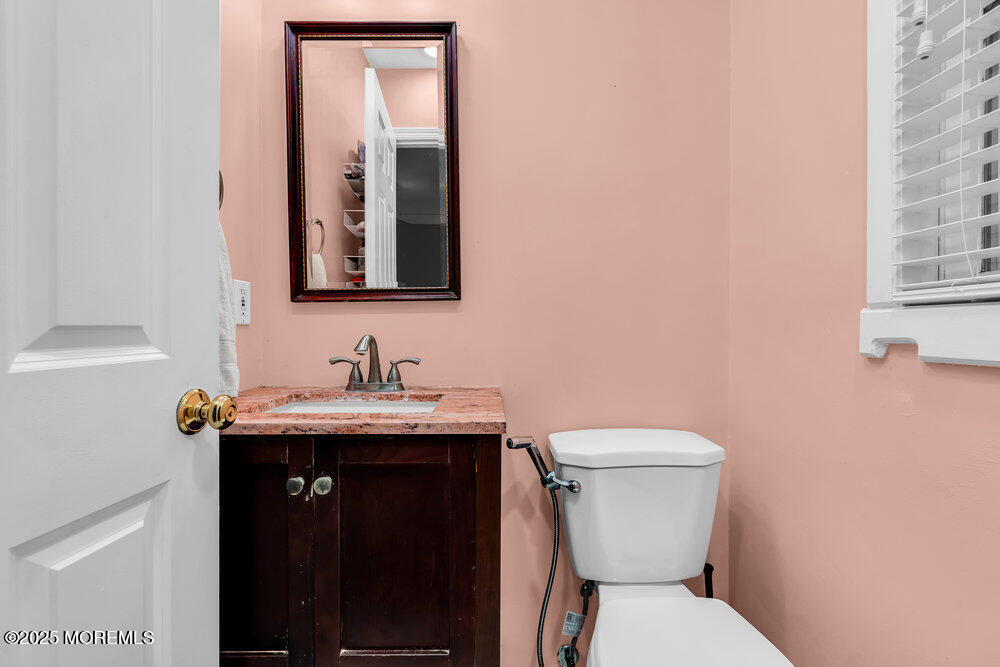345 Green Grove Road Tinton Falls, NJ 07712 - Photo 30 of 80 a bathroom with a granite countertop toilet a sink and a mirror