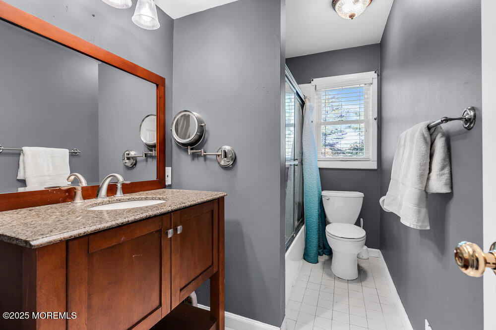 345 Green Grove Road Tinton Falls, NJ 07712 - Photo 33 of 80 a bathroom with a granite countertop sink and a mirror