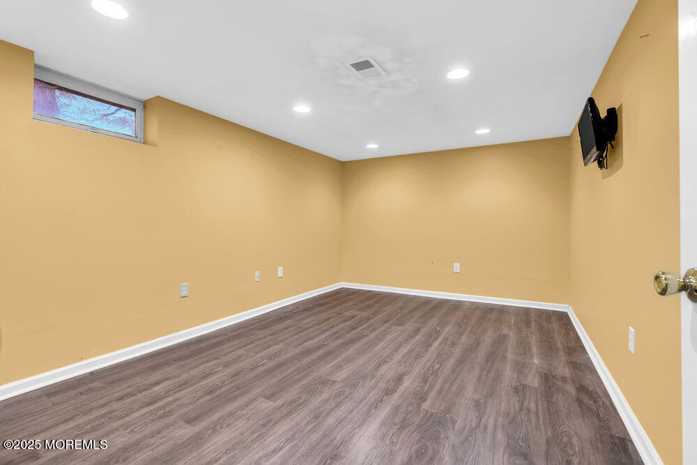345 Green Grove Road Tinton Falls, NJ 07712 - Photo 37 of 80 a view of a big room with wooden floor and windows