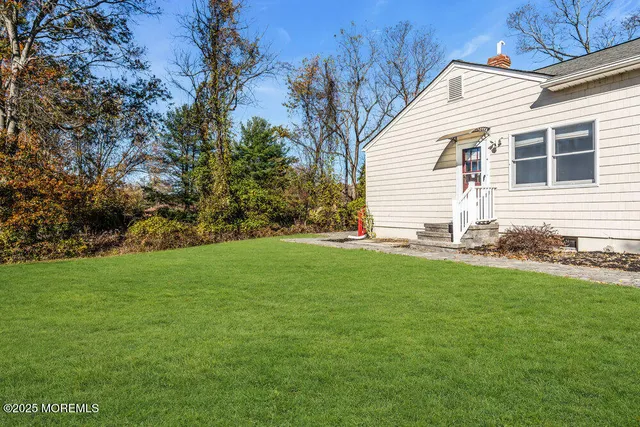 a view of a house with a yard and sitting area