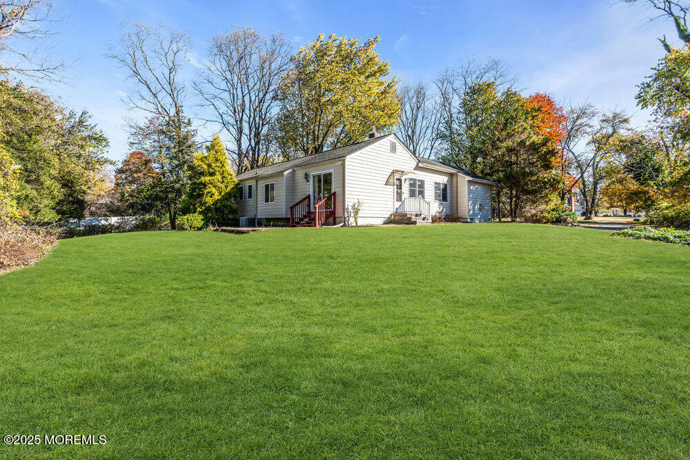345 Green Grove Road Tinton Falls, NJ 07712 - Photo 49 of 80 a front view of house with yard and trees