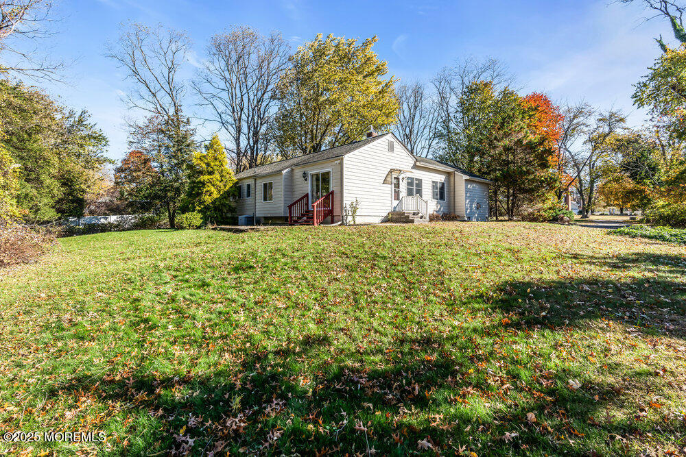 345 Green Grove Road Tinton Falls, NJ 07712 - Photo 53 of 80 a front view of a house with a garden and yard