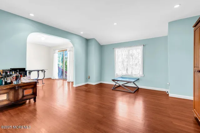a view of a room with wooden floor and furniture
