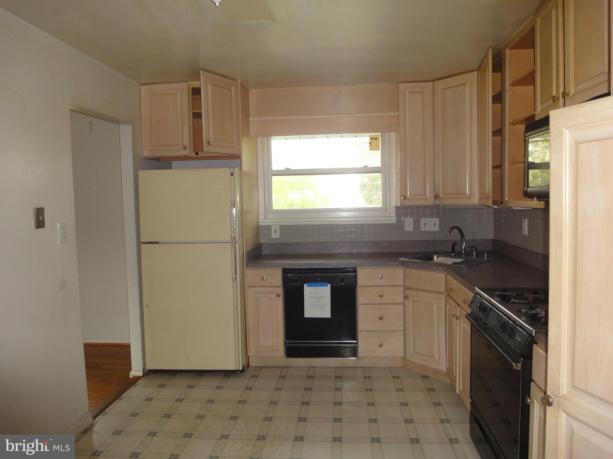 3905 Zurich Road Randallstown, MD 21133 - Photo 4 of 13 a kitchen with stainless steel appliances granite countertop a refrigerator sink and cabinets