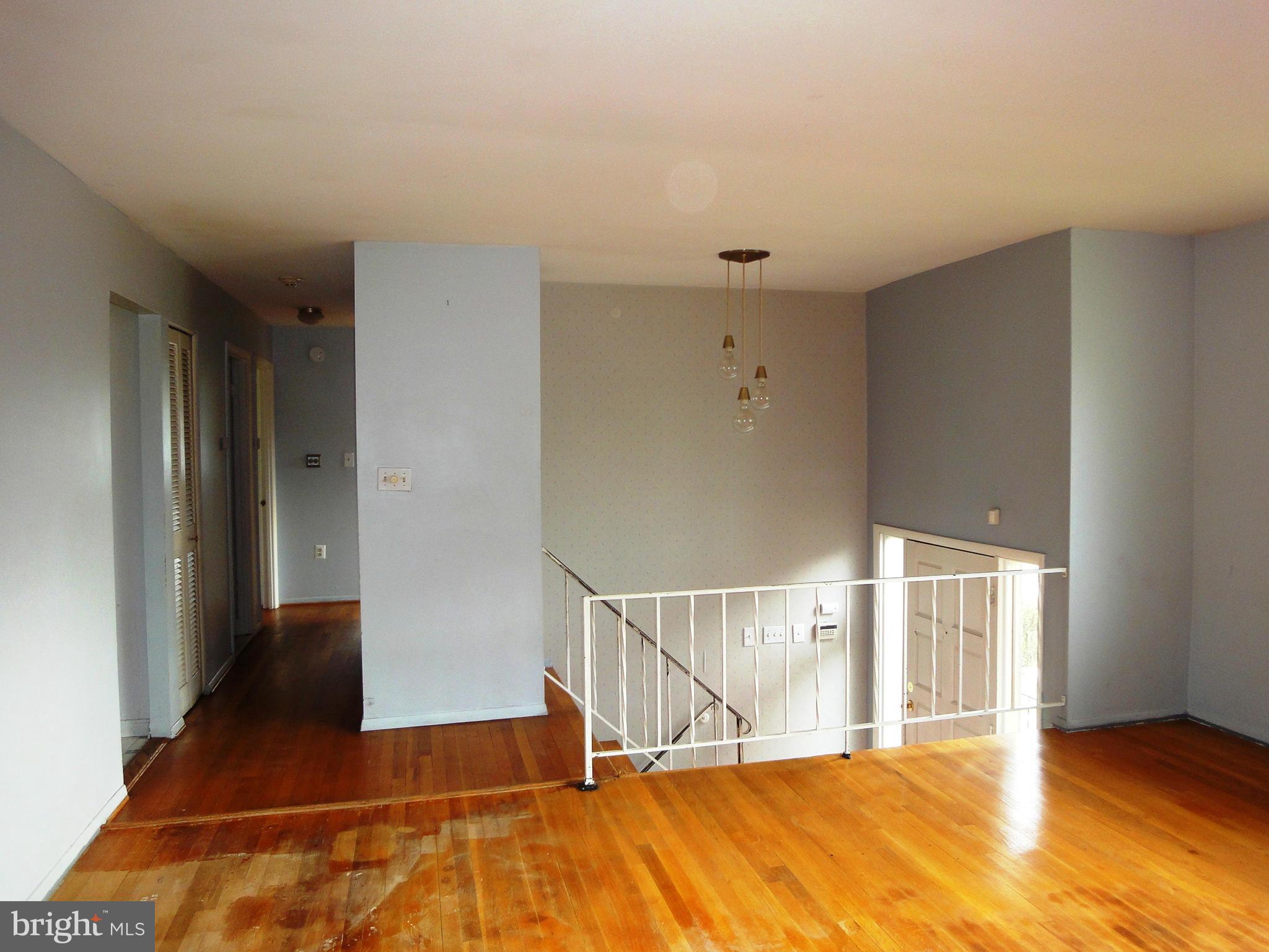 3905 Zurich Road Randallstown, MD 21133 - Photo 8 of 13 a view of an empty room with wooden floor and a window