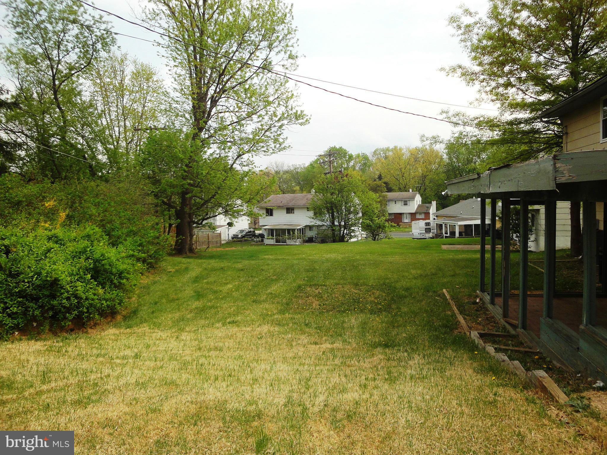3905 Zurich Road Randallstown, MD 21133 - Photo 9 of 13 a backyard of a house with plants and large trees