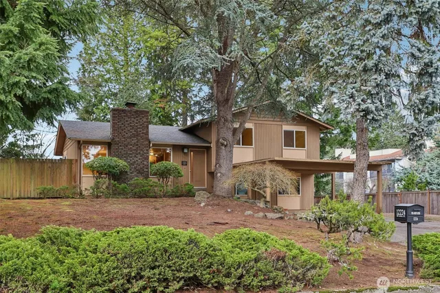 a front view of a house with a yard and potted plants