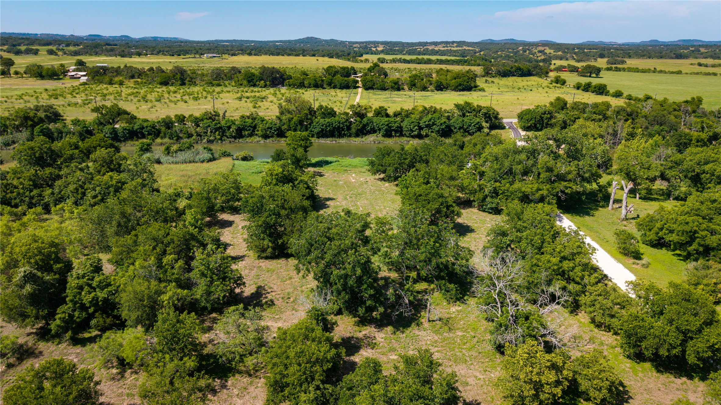 Tbd Lost Acres Loop Blanco, TX 78606 - Photo 33 of 39 a view of a green field with lots of trees in it
