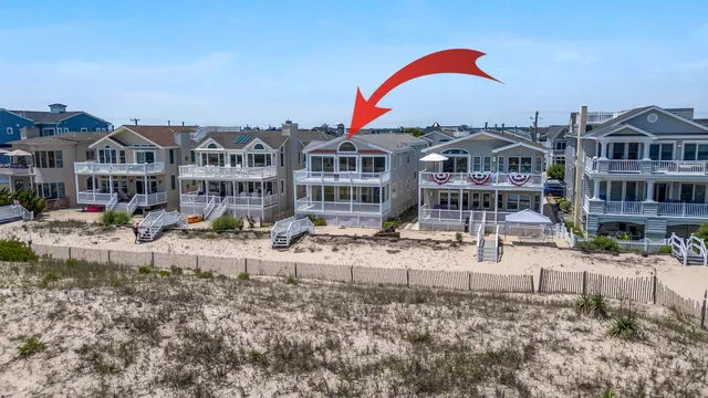 a front view of residential houses with yard and trees