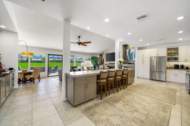 a view of a dining hall with couches and chandelier
