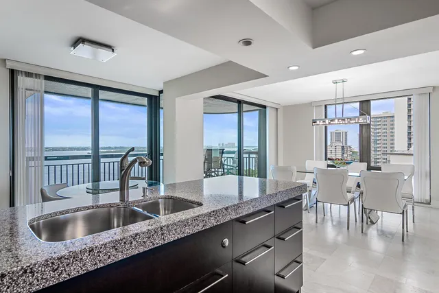a kitchen with granite countertop a sink and wooden cabinets