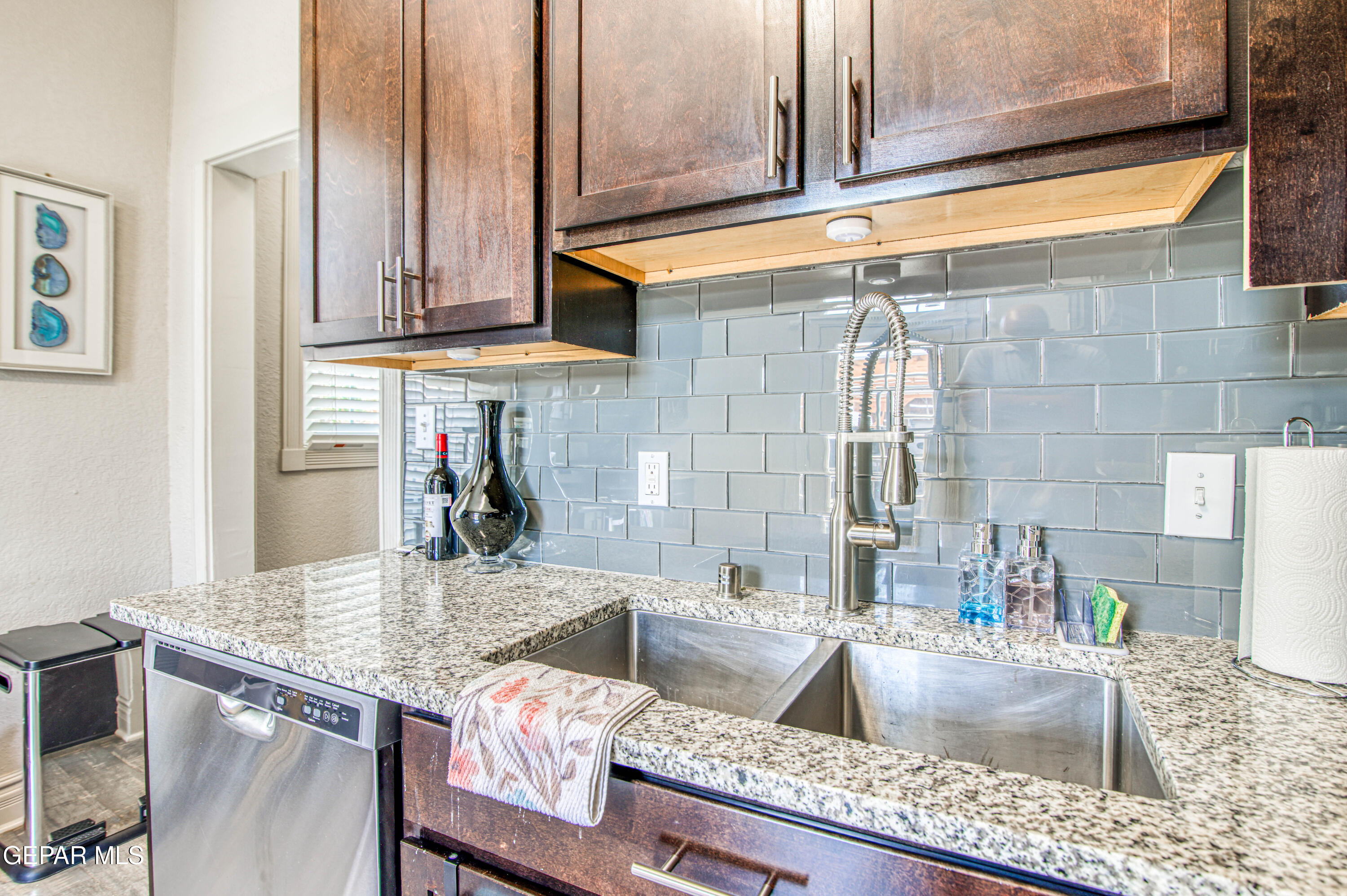 640 Stewart Court El Paso, TX 79902 - Photo 12 of 31 a kitchen with granite countertop a sink and a stove