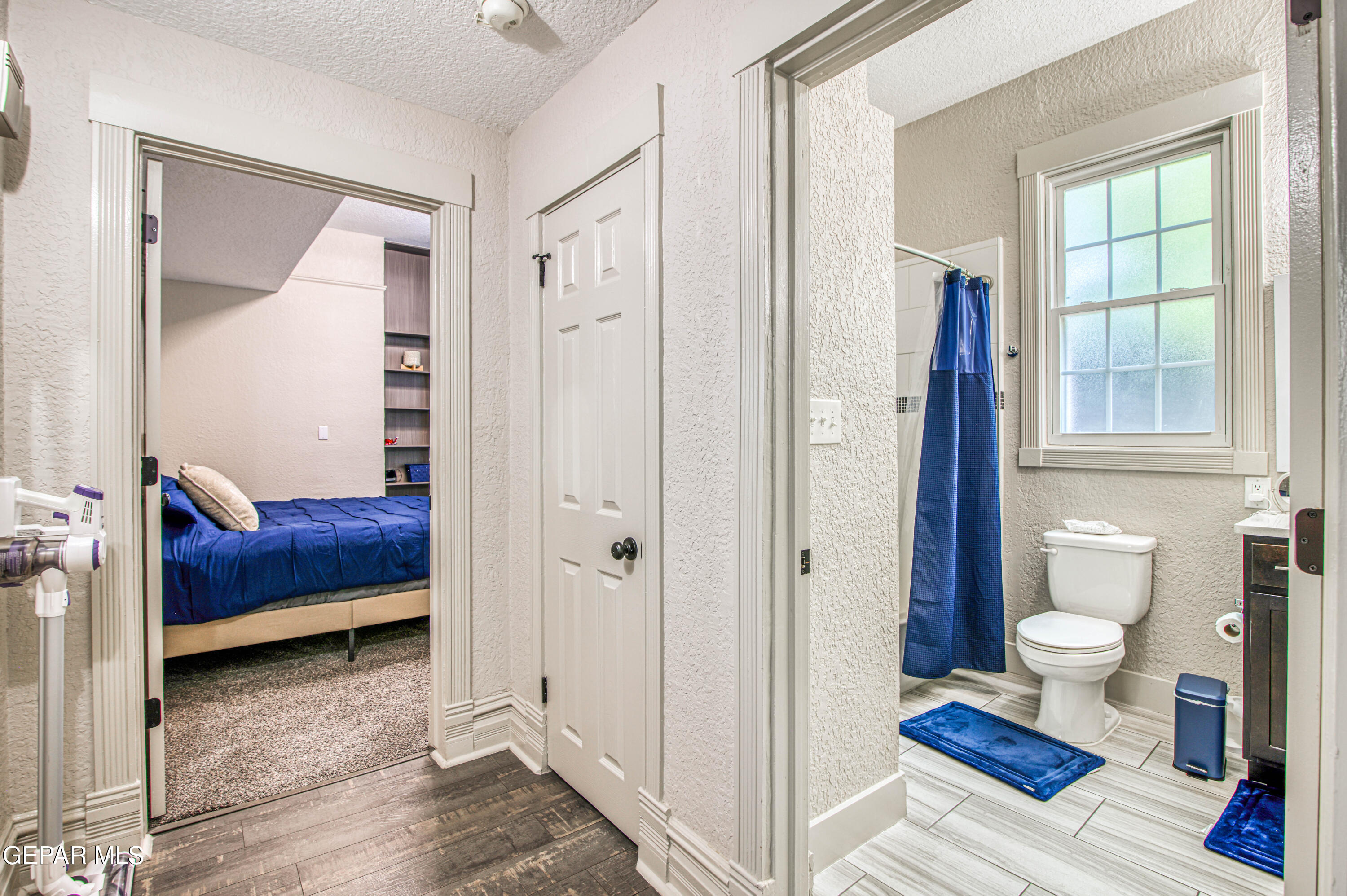640 Stewart Court El Paso, TX 79902 - Photo 13 of 31 a bedroom with a bed and wooden floor