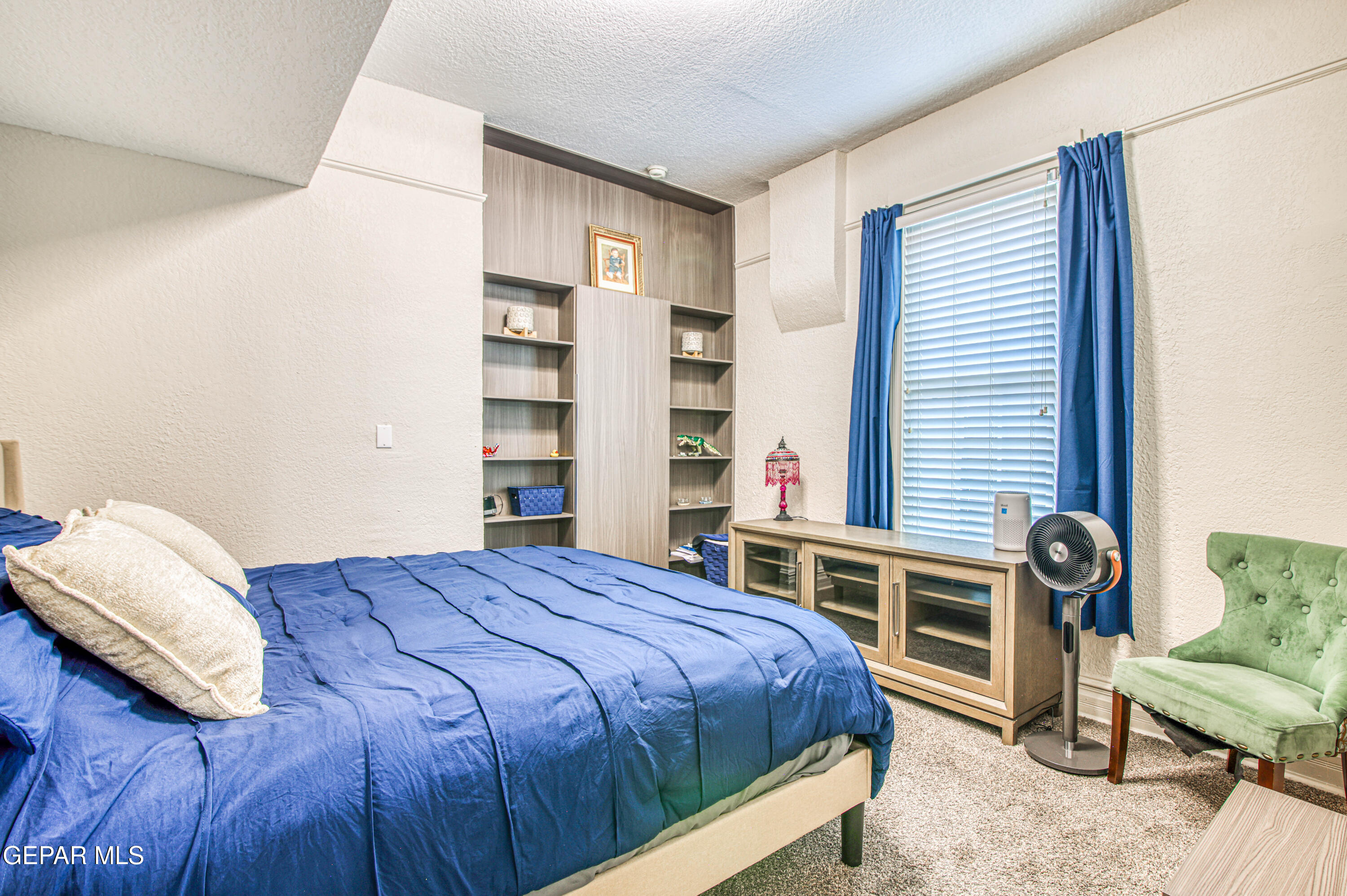 640 Stewart Court El Paso, TX 79902 - Photo 14 of 31 a bedroom with a bed and a chair