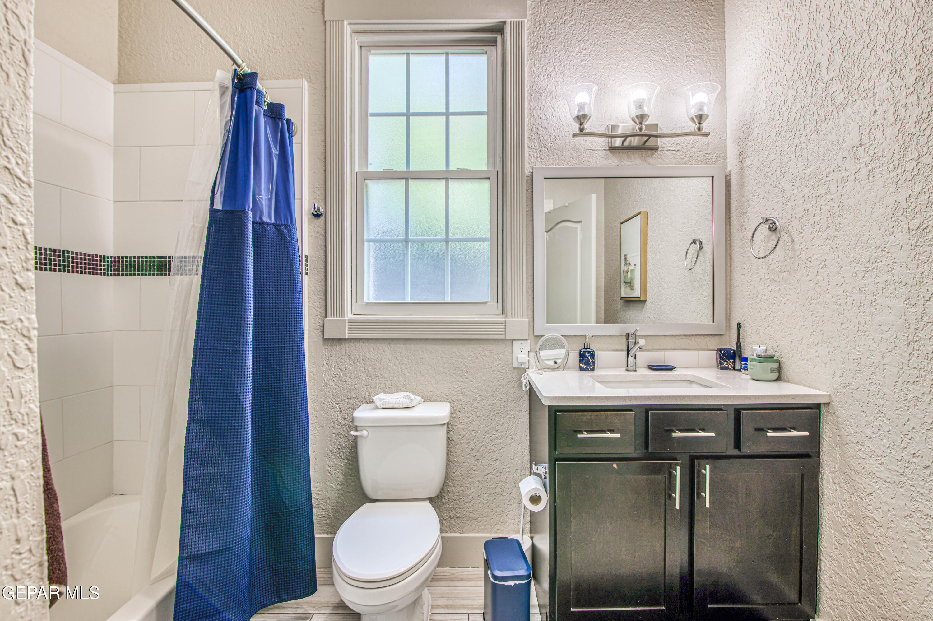 640 Stewart Court El Paso, TX 79902 - Photo 15 of 31 a bathroom with a toilet a sink and a mirror