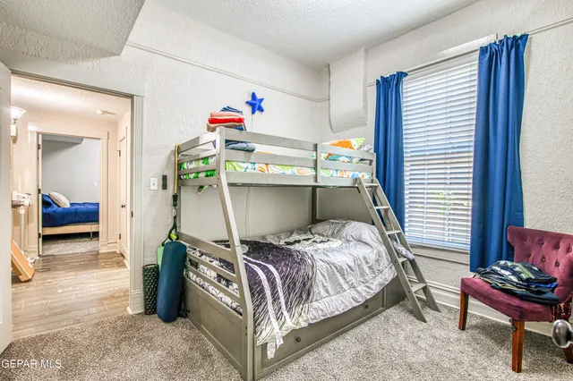 a bedroom with a bed and a chair