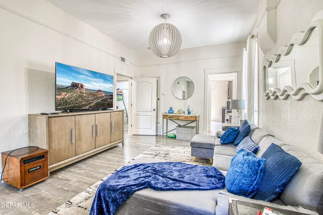 a living room with furniture a flat screen tv and a large window