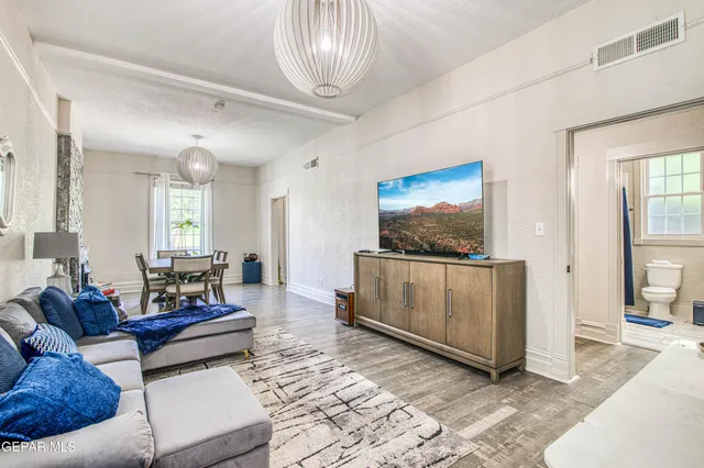 a living room with furniture and a flat screen tv
