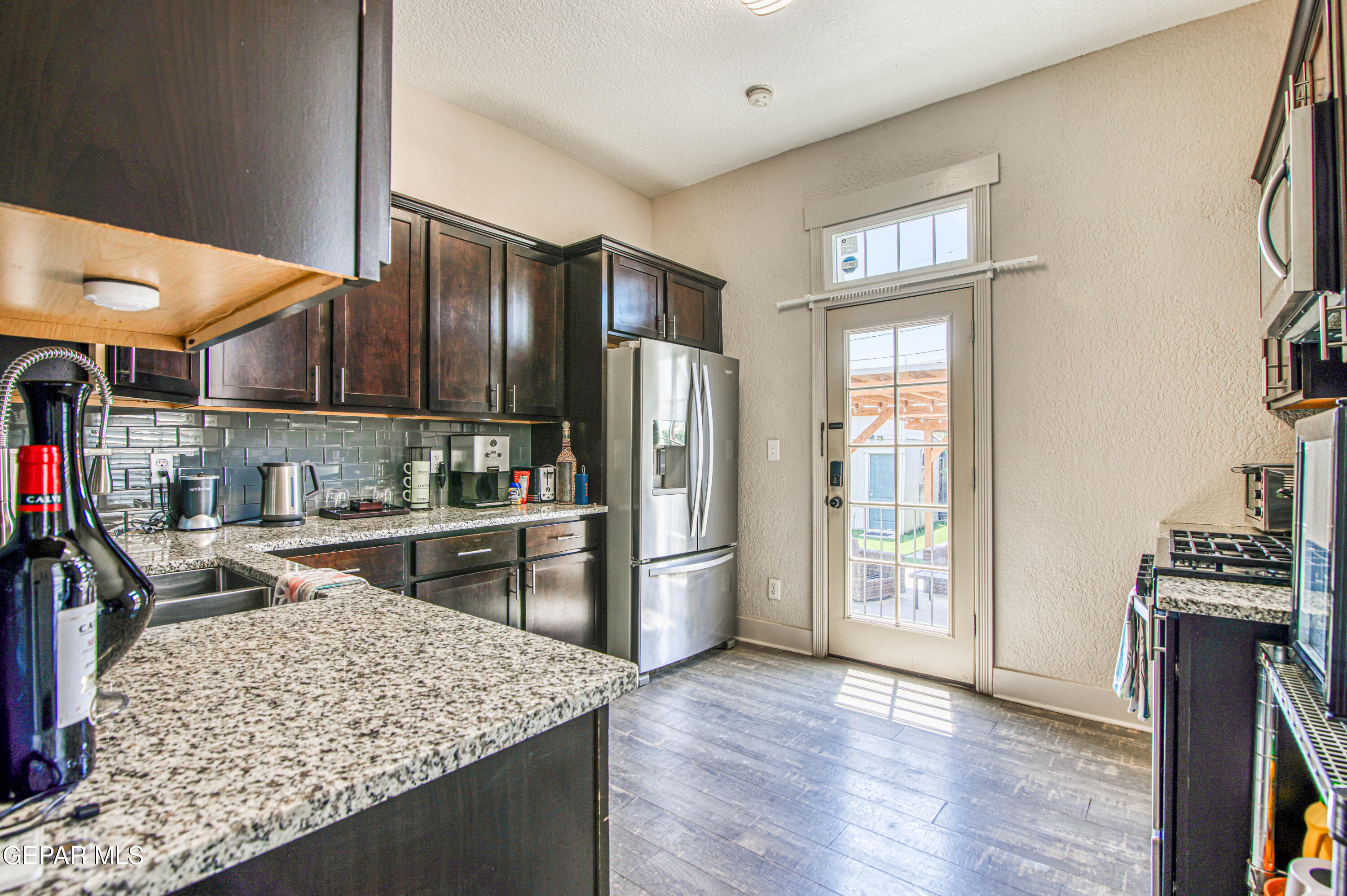 640 Stewart Court El Paso, TX 79902 - Photo 10 of 31 a kitchen with a refrigerator and a sink