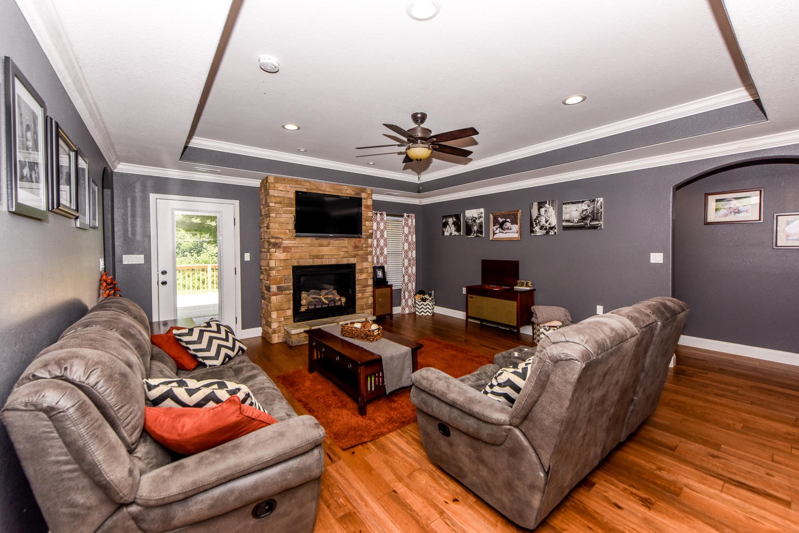 3150 Sam James Road Maryville, TN 37803 - Photo 7 of 35 a living room with furniture a flat screen tv and a fireplace