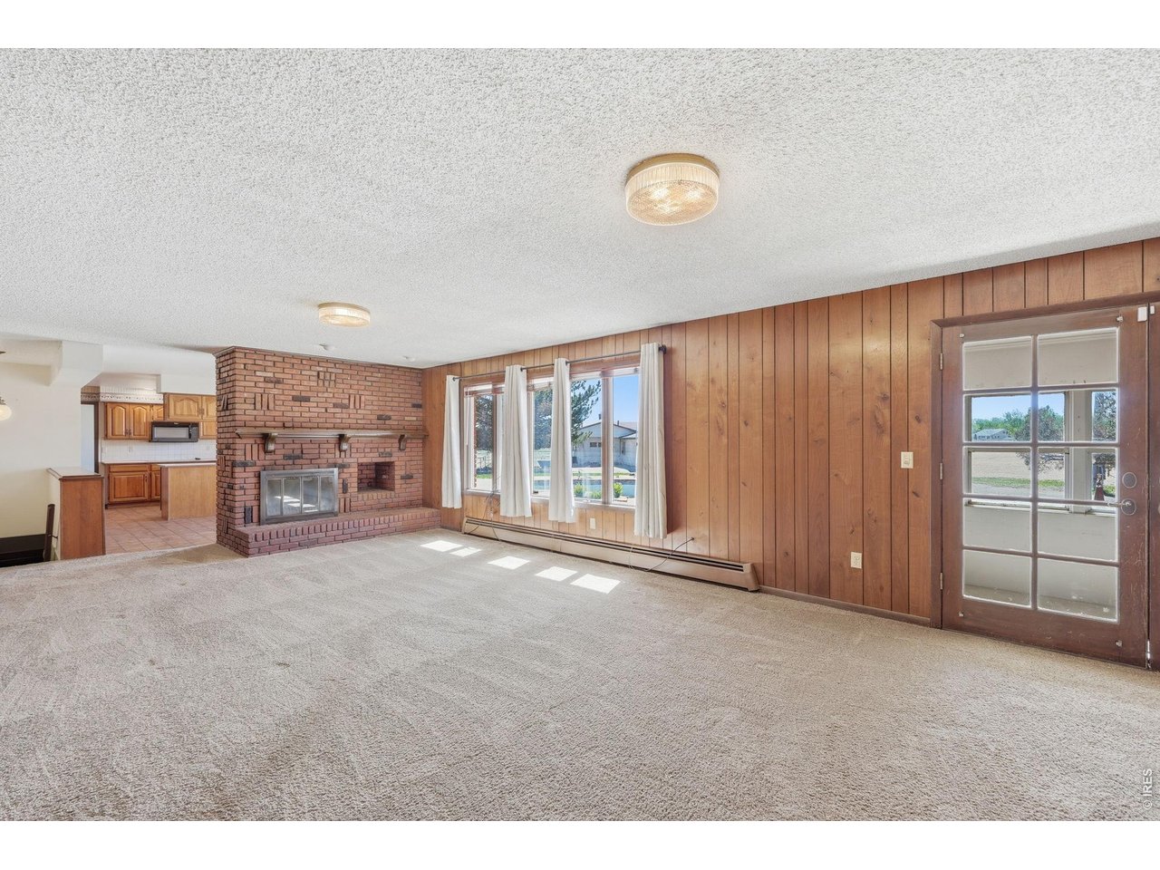 11098 Jasper Road Lafayette, CO 80026 - Photo 22 of 50 a view of an empty room with a fireplace and a large window