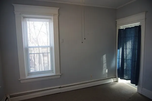 a bathroom with a sink toilet and window