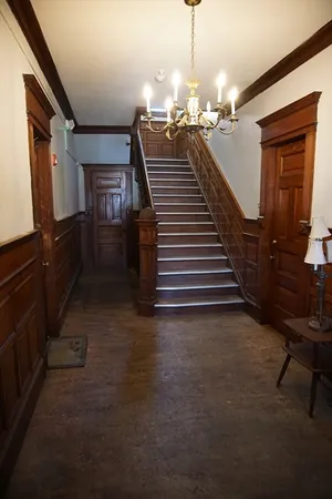 a view of a livingroom with wooden floor and stairs