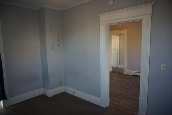 an empty room with windows and closet