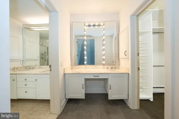 a bathroom with a granite countertop sink and a mirror