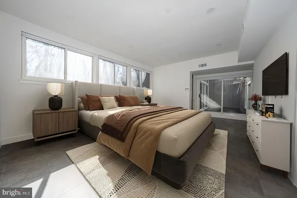 a bedroom with bed and flat screen tv