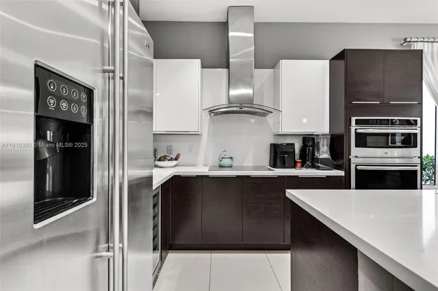 a kitchen with stainless steel appliances a sink and a refrigerator