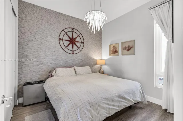 a bedroom with a bed and chandelier