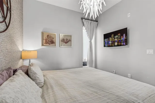 a bedroom with a bed and a lamp on table