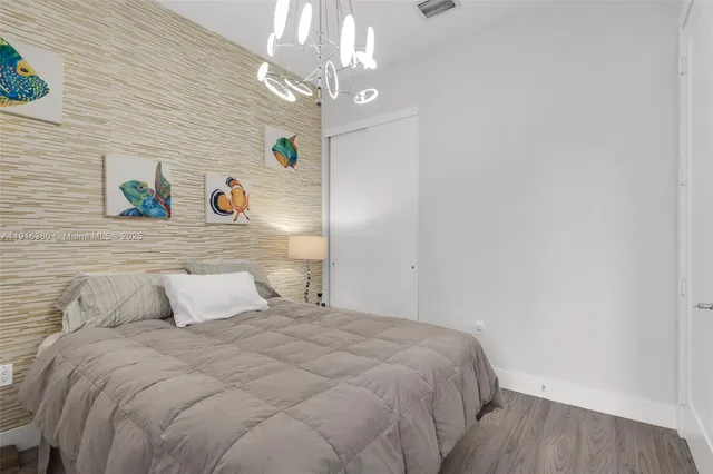 a bedroom with a bed and a chandelier