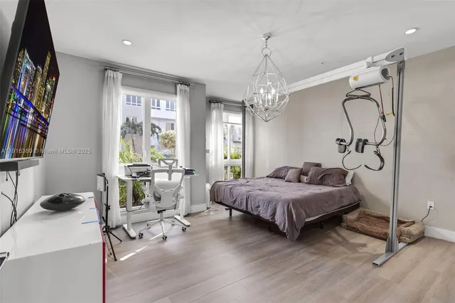a living room with a bed furniture and a flat screen tv